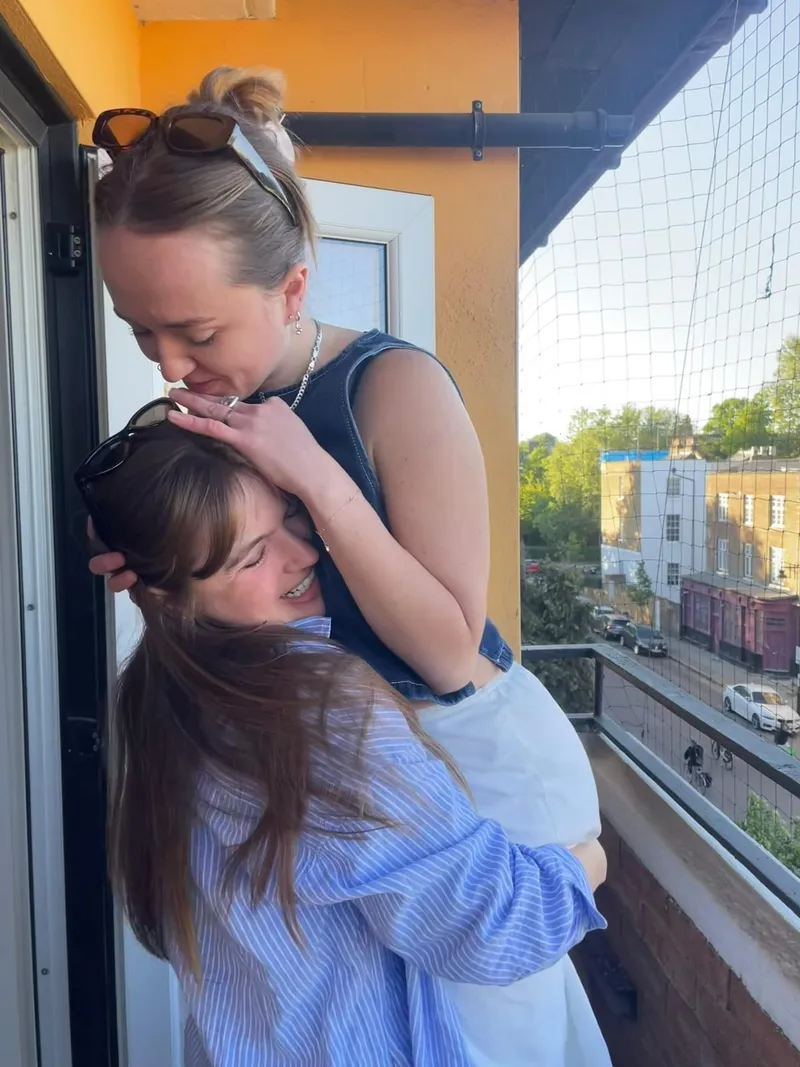 Rose being hugged on a sunny balcony